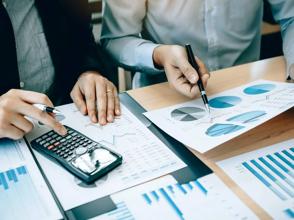 Analysts working through financial statements and charts